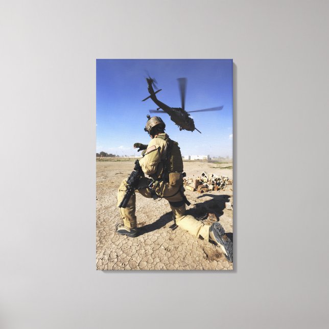 A soldier conducts security for an HH-60 Canvas Print (Front)