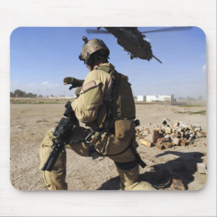 A soldier conducts security for an HH-60 Mouse Mat