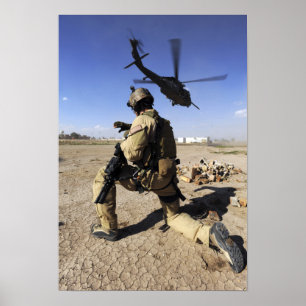 A soldier conducts security for an HH-60 Poster