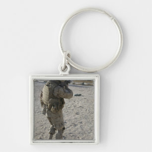 A soldier engages his target on a shooting rang key ring