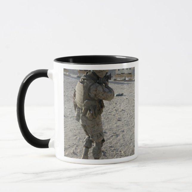 A soldier engages his target on a shooting rang mug (Left)