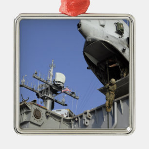 A soldier fast-ropes metal tree decoration