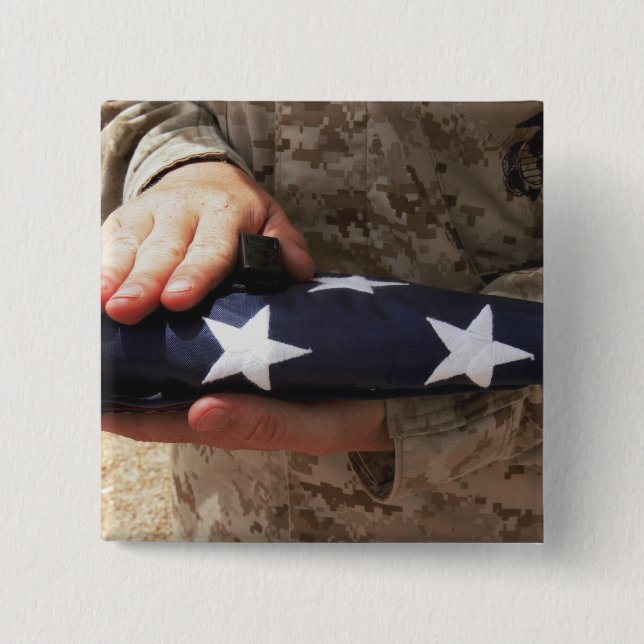 A soldier holds the United States flag 15 Cm Square Badge (Front)