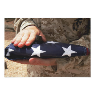 A soldier holds the United States flag Photo Print