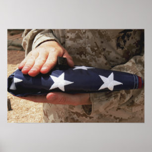 A soldier holds the United States flag Poster