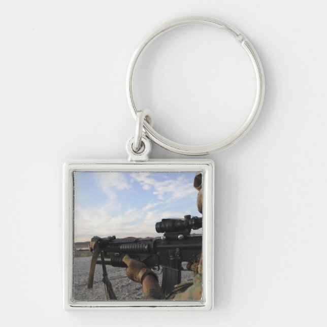 A soldier sights in to fire on a target key ring (Front)