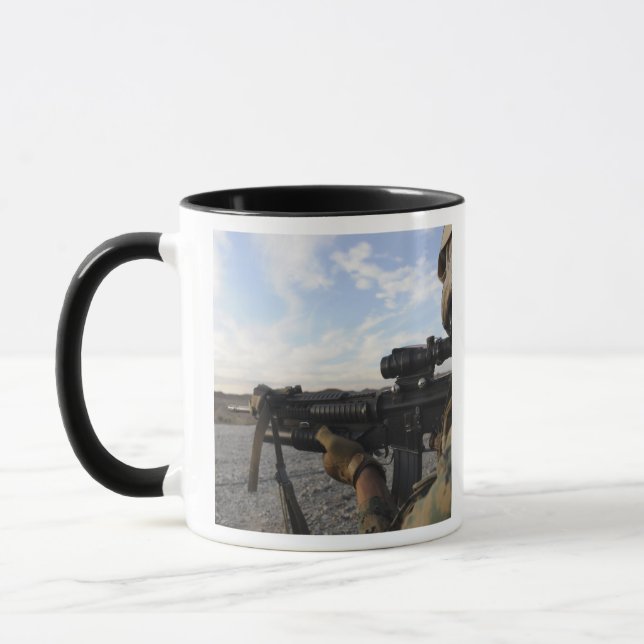 A soldier sights in to fire on a target mug (Left)