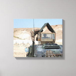 A soldiier instructs an Iraqi army soldier Canvas Print