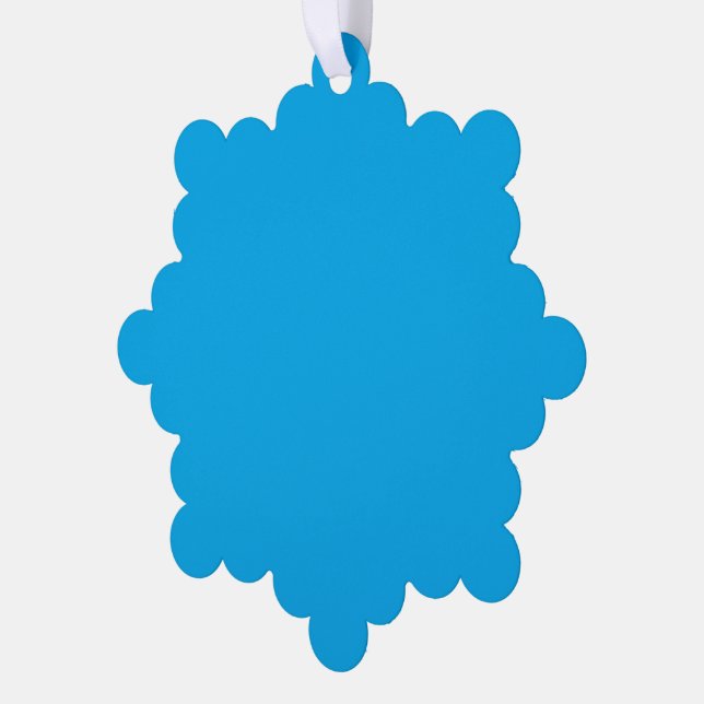 A solid bright blue background fills  tree decoration card (Left)