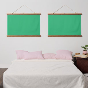 A solid green square positioned on a white backdro hanging tapestry
