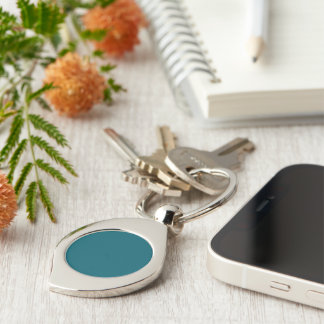 A solid teal background fills the image key ring