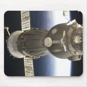 A Soyuz spacecraft backdropped by Earth Mouse Mat