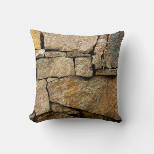 A stone wall made of cobblestones background textu cushion