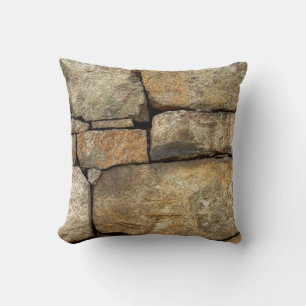 A stone wall made of cobblestones background textu cushion