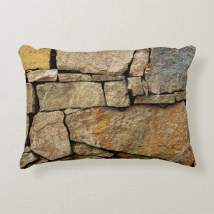 A stone wall made of cobblestones background textu decorative cushion