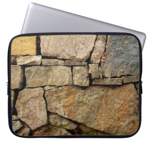 A stone wall made of cobblestones background textu laptop sleeve