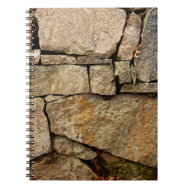 A stone wall made of cobblestones background textu notebook (Front)
