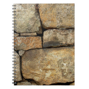 A stone wall made of cobblestones background textu notebook