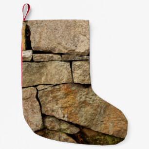A stone wall made of cobblestones background textu small christmas stocking
