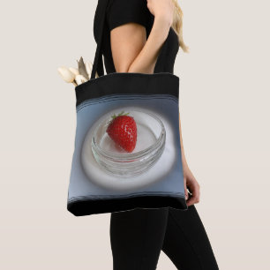 A strawberry in a cup tote bag