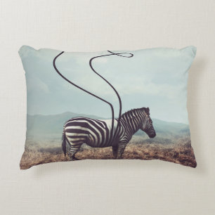 A surreal image of a zebra and two of its black st decorative cushion