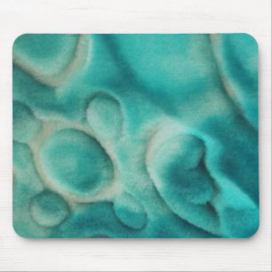 A swirling pattern in teal and light beige mouse mat
