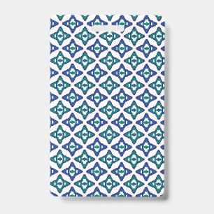 A symmetrical blue and white rug with intricate mo ID badge