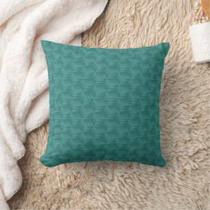 A teal, geometric-patterned throw pillow