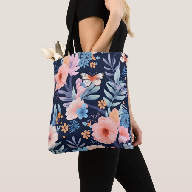 A tote bag with black straps features a vibrant  (Close Up)