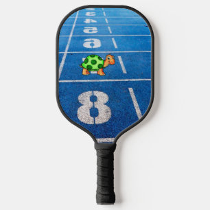 A turtle in a marathon race pickleball paddle