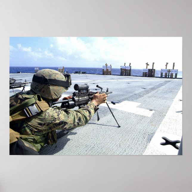 A US Marine adjusting his weapon Poster (Front)