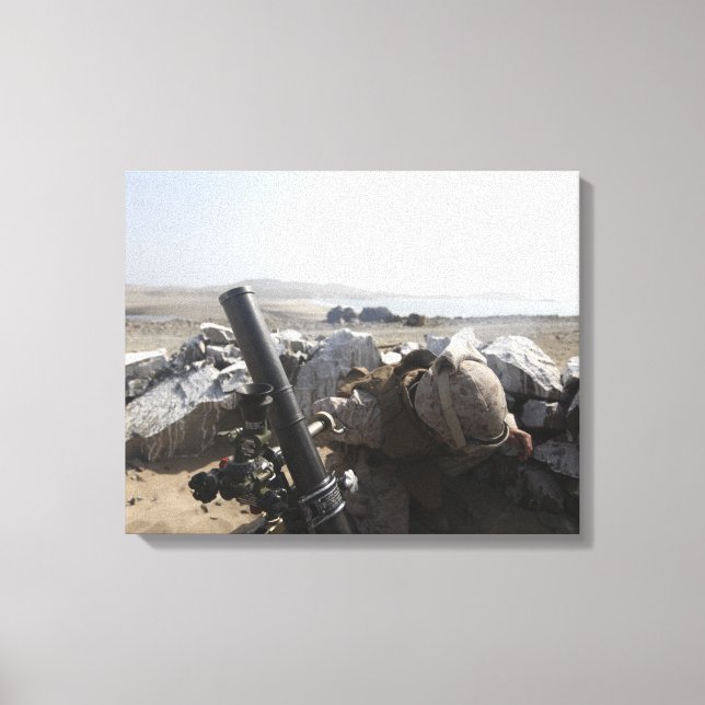 A US Marine fires a mortar in Salinas, Peru Canvas Print (Front)