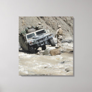 A US Marine guiding the driver of a Humvee Canvas Print