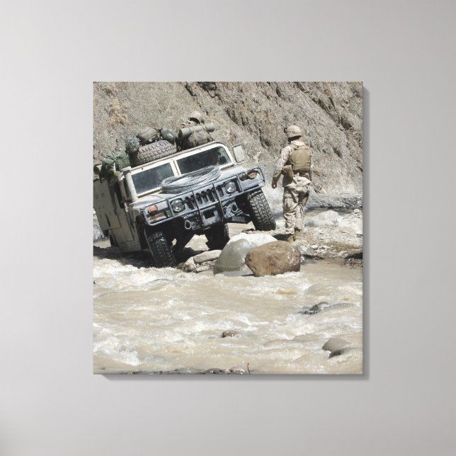 A US Marine guiding the driver of a Humvee Canvas Print (Front)