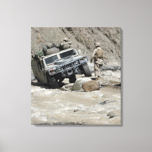 A US Marine guiding the driver of a Humvee Canvas Print (Front)