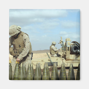 A US Marine prepares howitzer rounds to be fire Magnet
