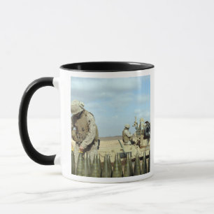 A US Marine prepares howitzer rounds to be fire Mug