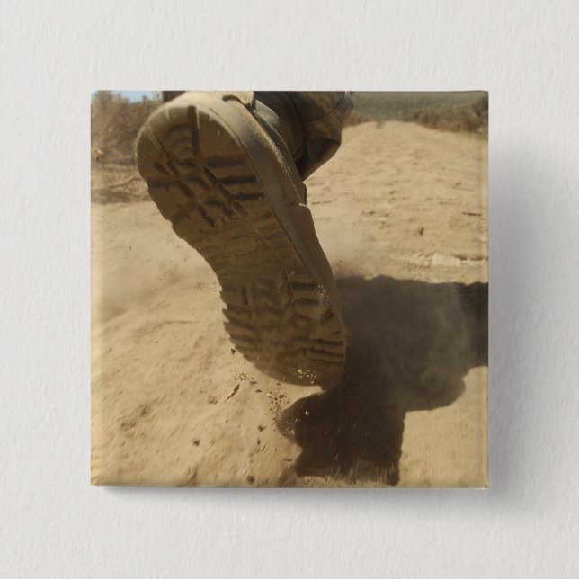 A US soldier walks along a dirt path 15 Cm Square Badge (Front)