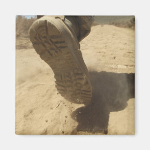 A US soldier walks along a dirt path Magnet