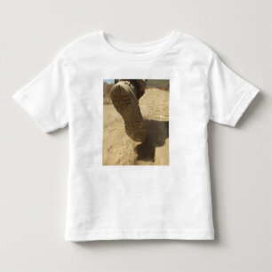 A US soldier walks along a dirt path Toddler T-Shirt