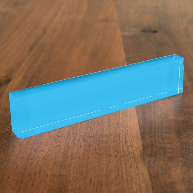 A vibrant blue sky with a few scattered white clou nameplate (Side)