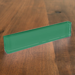 A vibrant green leaf with distinct veins is illumi nameplate