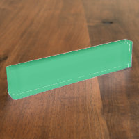A vibrant green leaf with prominent veins and a de