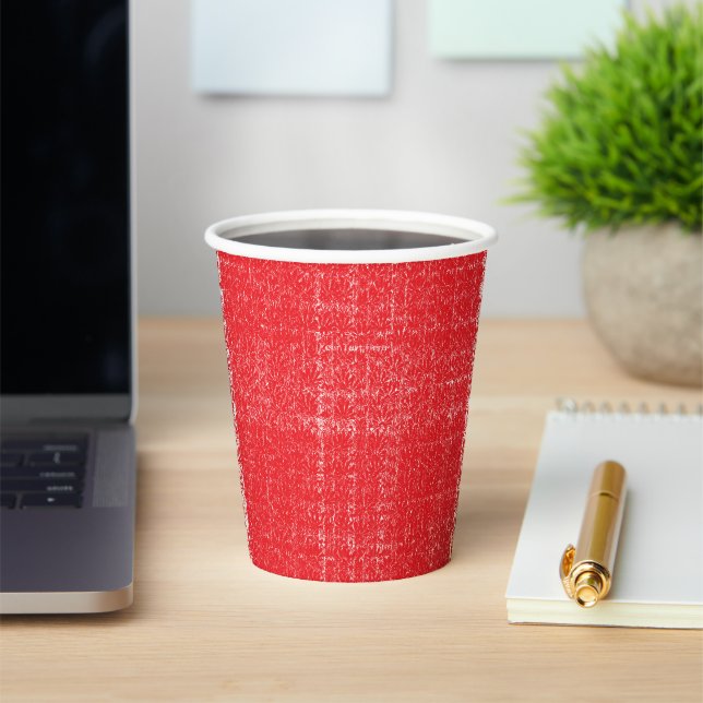 A vibrant red rose with dewdrops gently resting on paper cups (Insitu)