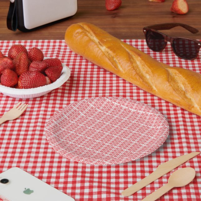 A vibrant red rose with dewdrops gently resting on paper plate (Picnic)