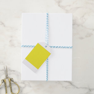 A vibrant yellow square enclosed by a crisp white  gift tags