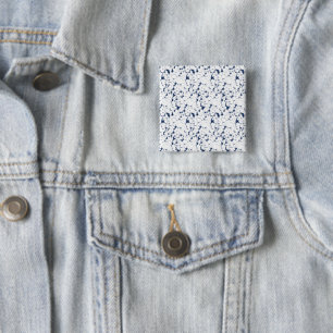 a white and blue background with a pattern 15 cm square badge