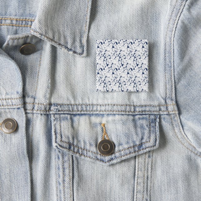 a white and blue background with a pattern 15 cm square badge (In Situ)