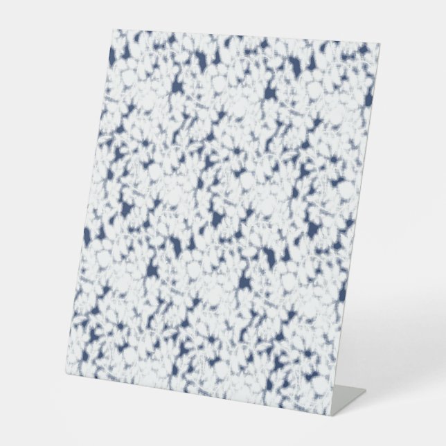 a white and blue background with a pattern pedestal sign (Front)