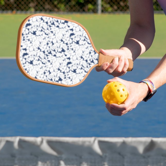 a white and blue background with a pattern pickleball paddle (Insitu)